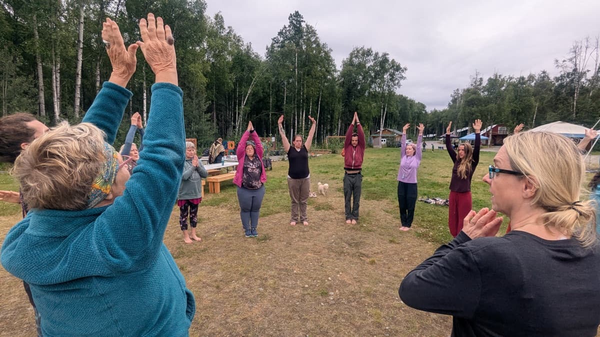 Group circle with arms raised